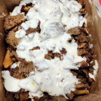 Aladdin Gyro-Cery - Box of Aladdin's Fries topped with Beef & Lamb gyro meat and garlic sauce (5/26/24) - Greek Near Me - Seattle, Washington Aladdin Gyro-Cery - Box of Aladdin's Fries topped with Beef & Lamb gyro meat and garlic sauce (5/26/24) - Greek Near Me - Seattle, Washington