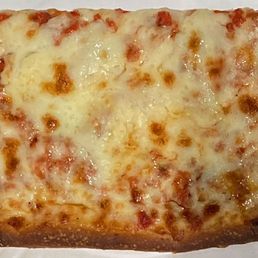 Large grandma cheese slice made with a garlicky tomato sauce Large grandma cheese slice made with a garlicky tomato sauce