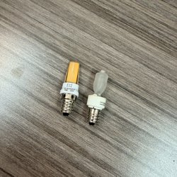 Commercial Lighting Specialties - E12 candelabra-base halogen bulb. New on left and right is old.