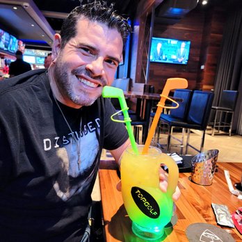 Topgolf - Pineapple punch in a souvenir cup - New American Near Me - Orlando, Florida Topgolf - Pineapple punch in a souvenir cup - New American Near Me - Orlando, Florida