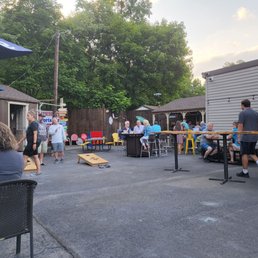 a group of people sitting at tables outside