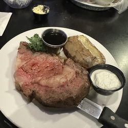 Prime Rib, 12 ounces with a baked potato. The au jus is in the silver cup. The sour cream is for the potato, and was not horseradish sauce