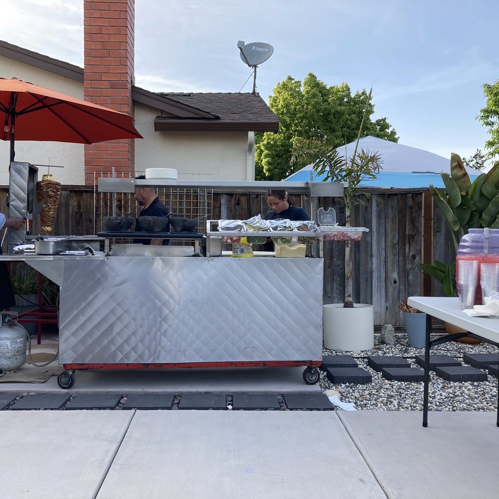 Tijuas Tacos - a man preparing a taco - Caterers Near Me - San Jose, California Tijuas Tacos - a man preparing a taco - Caterers Near Me - San Jose, California