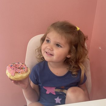 Clear Falls Donuts - a little girl holding a donut - Donuts Near Me - League City, Texas