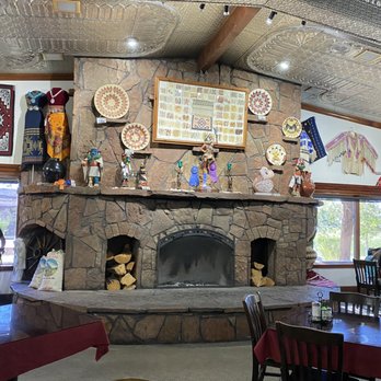 Cameron Trading Post - Stone fireplace with Hopi and Navajo art in dining room. - Hotels Near Me - Cameron, Arizona