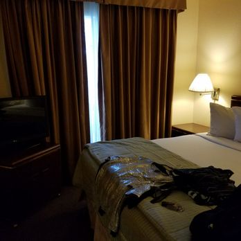 Habitat Suites - Bedroom 1 with Tv, dresser, closet and nightstand Comfortable bed! - Hotels Near Me - Austin, Texas Habitat Suites - Bedroom 1 with Tv, dresser, closet and nightstand Comfortable bed! - Hotels Near Me - Austin, Texas