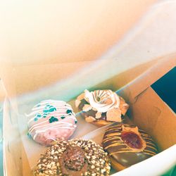 The Local Donut - Cranberry donut with white chocolate stripes and orange filled, s'mores donut, Nutella donut, and pb&j donut.