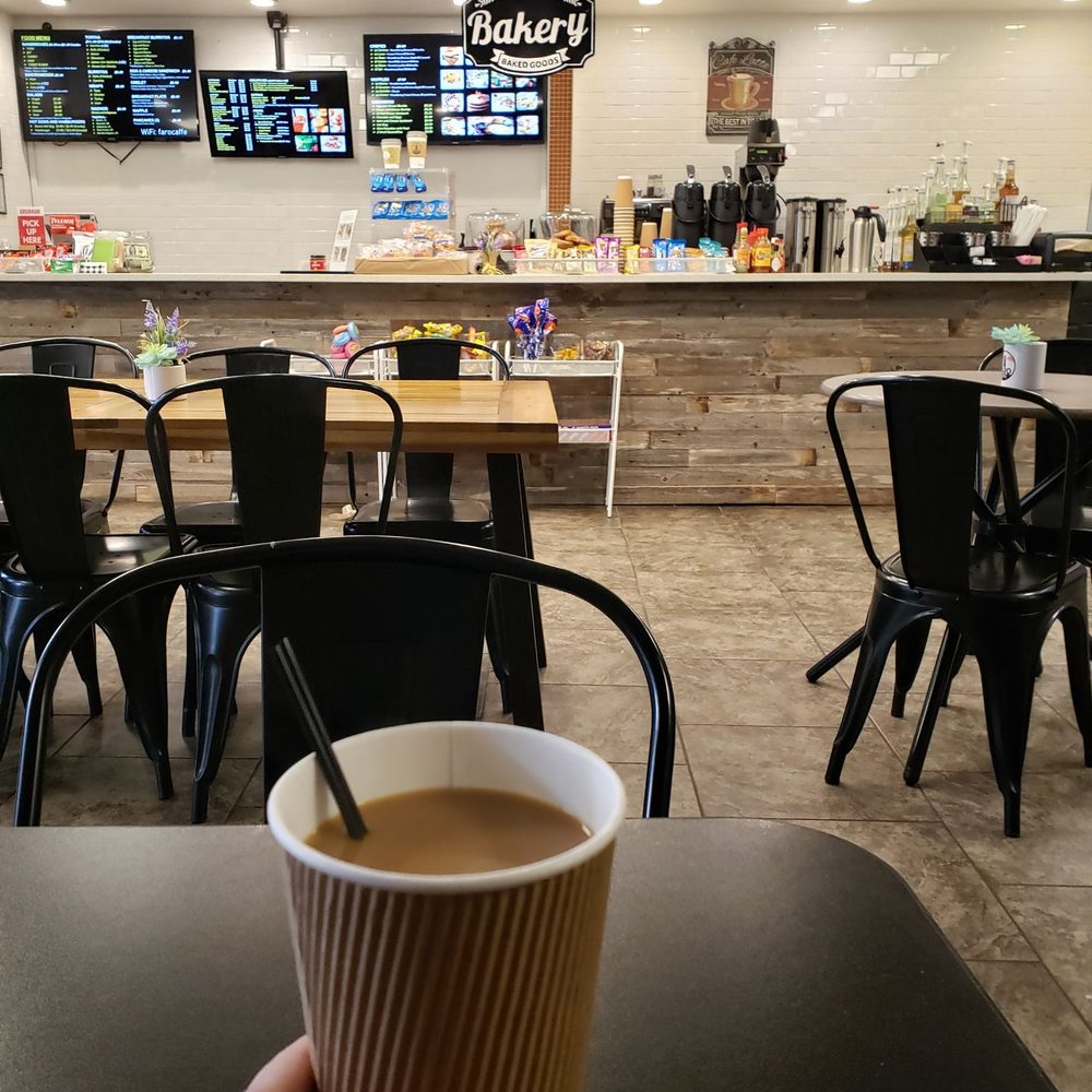 Faro Caffe - a person holding a cup of coffee - Coffee & Tea Near Me - Dallas, Texas