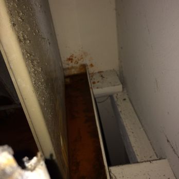 Legend Oaks Apartments - Ac unit drip pan with rusty and mildew water in a damp dark closet located inside apartment - Apartments Near Me - Tampa, Florida