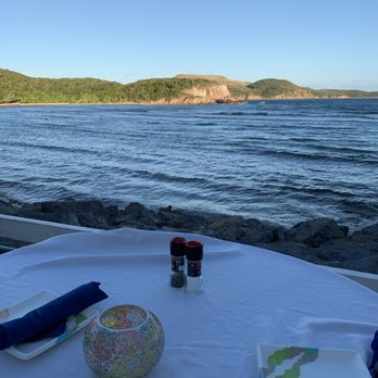 Mim's Seaside Bistro - Ocean front table right before sunset, although you can't really see a sunset from this side of the island. - Seafood Near Me - St Thomas, Virgin Islands Mim's Seaside Bistro - Ocean front table right before sunset, although you can't really see a sunset from this side of the island. - Seafood Near Me - St Thomas, Virgin Islands