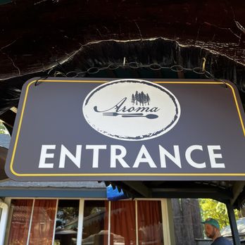 Aroma Restaurant - a man standing in front of the entrance - Desserts Near Me - Ben Lomond, California