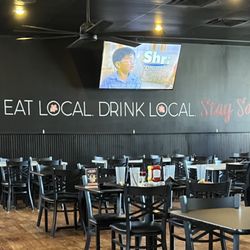 Dining area, with the slogan, "Eat Local Drink Local Stay Social"
