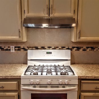 CK Construction - a kitchen with a stove and cabinets - General Contractors Near Me