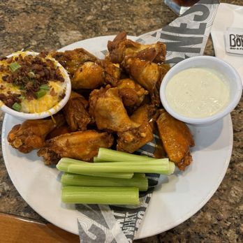 Smokey Bones - 12 fried buffalo hot wings with a side of loaded mashed potatoes. - Barbeque Near Me - Peachtree City, Georgia Smokey Bones - 12 fried buffalo hot wings with a side of loaded mashed potatoes. - Barbeque Near Me - Peachtree City, Georgia