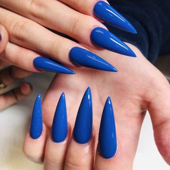 007 Nails - Hands with long, pointed, blue acrylic nails are shown, highlighting a professional manicure with a glossy finish. - Nail Salons Near Me - Madison, Wisconsin