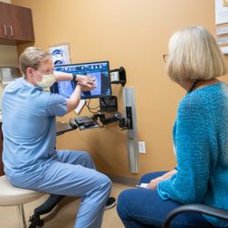 Neurosurgery One - Lakewood - Dr. Beckman explains scoliosis to patient.