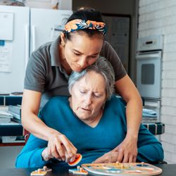 Select Home Care - One of our Caregivers helping senior clients play an activity.