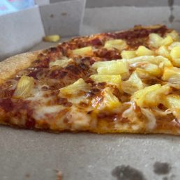 a slice of pineapple pizza