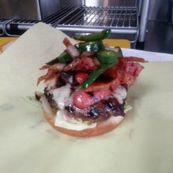 Brauts & Hots - El cuycuy burger! It has a hot dog, bacon, chili, fresh grilled jalapeno, grilled onion, cheese , all on a juicy, thick patty!