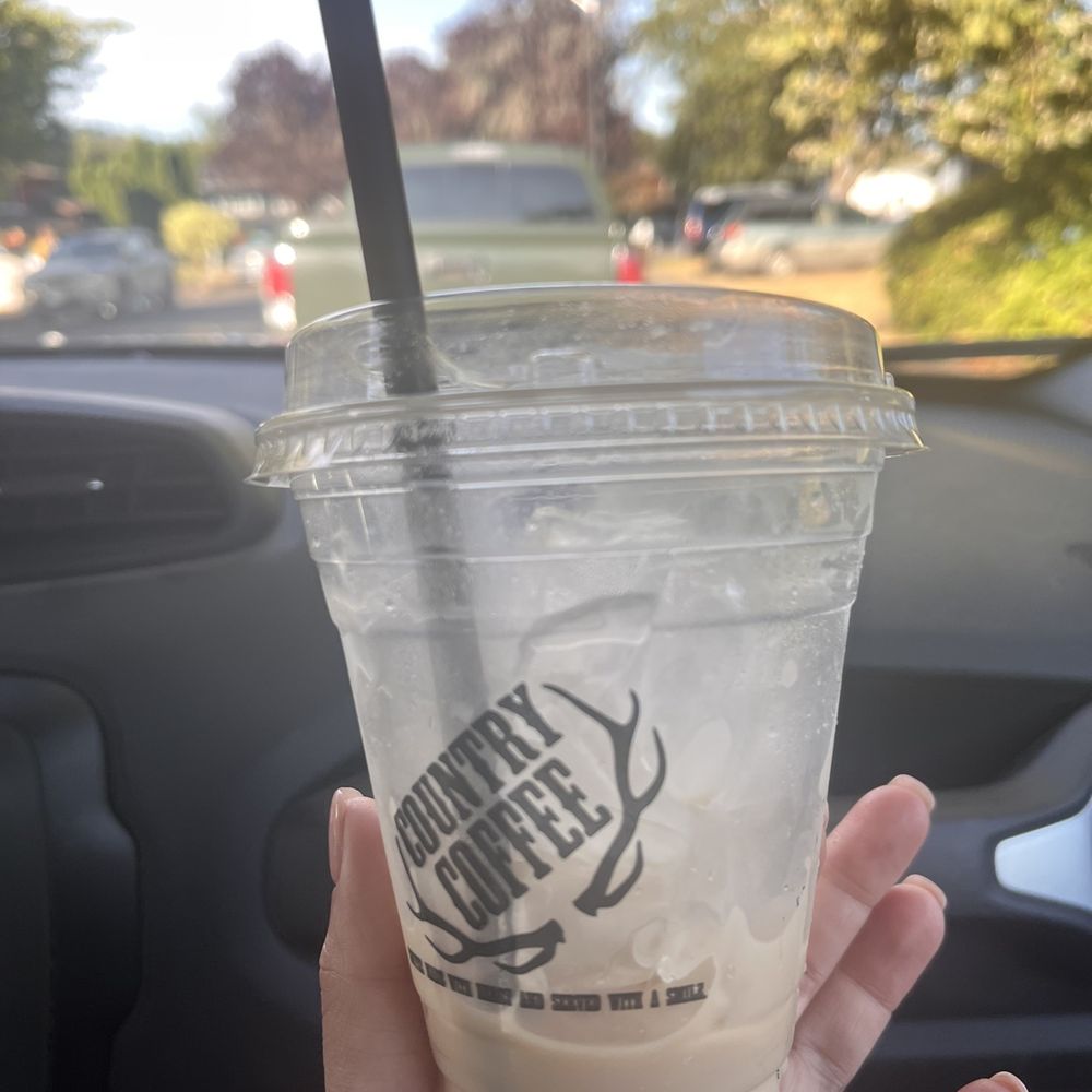 a hand holding a cup of coffee