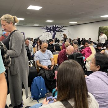 Heathrow Airport Terminal 3 - Small portion of passengers being crammed into a small holding pen prior to boarding - Airport Terminals Near Me - Longford, XGL