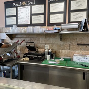Bagel Villa - a man preparing food in a kitchen - Sandwiches Near Me - Brooklyn, New York