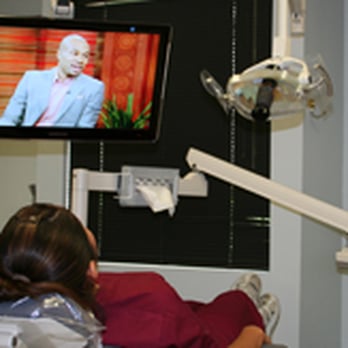 Adomian Garo, DDS - Fully adjustable monitors with headphones so patients can watch a movie or listen to music during treatment - General Dentistry Near Me - Burbank, California