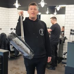 Keep it Dangerous Barbers - Owner Wayne waving a brush around. Great business man.