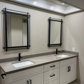 Masone Construction - a bathroom with two sinks and mirrors - General Contractors Near Me Masone Construction - a bathroom with two sinks and mirrors - General Contractors Near Me