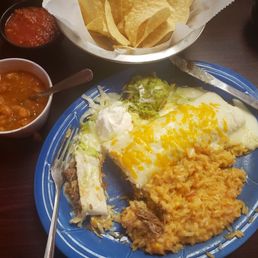 Shredded beef burrito with sour cream sauce, rice and borracho beans