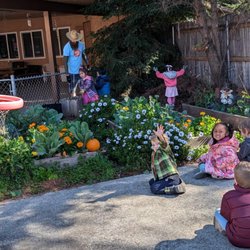 Little Sprouts Preschool - Farmer Eric on Fridays in the school garden. Children learn about gardening.
