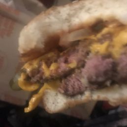 a hamburger with cheese and pickles a hamburger with cheese and pickles