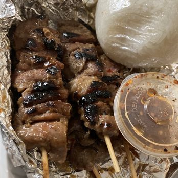 Thai Ghang Waan - Grilled pork skewers serve with a handful of sticky rice and dried chili dipping sauce. - Thai Near Me - Springfield, Virginia Thai Ghang Waan - Grilled pork skewers serve with a handful of sticky rice and dried chili dipping sauce. - Thai Near Me - Springfield, Virginia