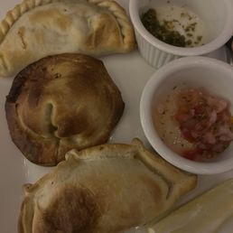 Beef, chicken, and cheese empanadas with chimichurri & salsa dips.