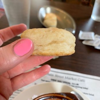 Main Street Market Cafe - a hand holding a biscuit over a bowl of soup - Cajun/Creole Near Me - Vicksburg, Mississippi