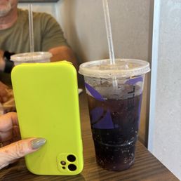 The tiny medium drink compared to a small phone. The tiny medium drink compared to a small phone.