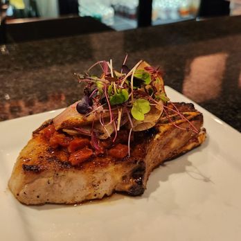 The Blackberry Brasserie - Pork chop. Comes with gnocchi (not pictured) - Cocktail Bars Near Me - Rogers, Arkansas