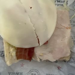 Jimmy John's - A half of a "favorites menu" turkey sub with two paper thin slices of turkey and a paper thin slice of cheese which is an up-charge.