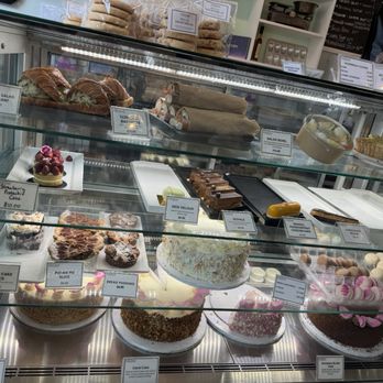 Verzenay - Glass display case showcasing various baked goods including cakes, pastries, and cookies in a bakery or patisserie setting. - Desserts Near Me - Chicago, Illinois