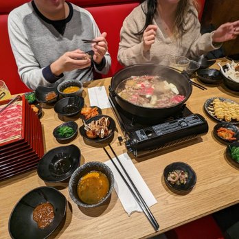 Kumo Sukiyaki - two people sitting at a table with bowls of food - Japanese Near Me - Richmond, British Columbia
