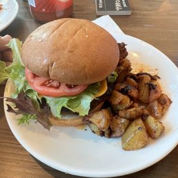 Garlic burger with side of fried potatoes with onions