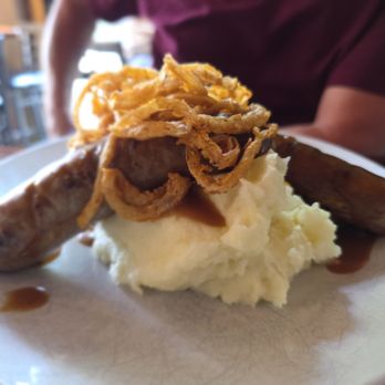 Friar Tuck's Tavern - Bangers & mash. Salty sausage, lots of mash, tasty onion strings. - Irish Near Me - Mystic, Connecticut Friar Tuck's Tavern - Bangers & mash. Salty sausage, lots of mash, tasty onion strings. - Irish Near Me - Mystic, Connecticut