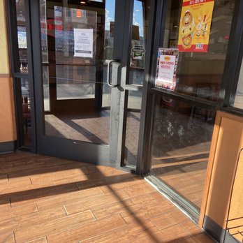 Denny's - a white dog standing in front of a store - Diners Near Me - Gallup, New Mexico