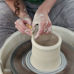 The Art Center - TAC instructor demonstrating how to throw a cylinder