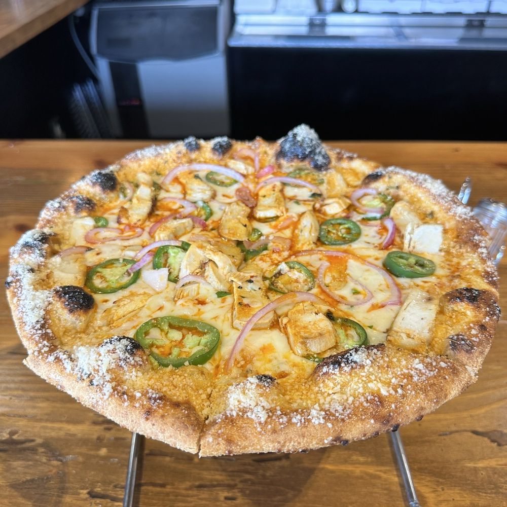 The Engineer - Buffalo chicken, red onion, jalapeños, Parmesan cheese across the crust The Engineer - Buffalo chicken, red onion, jalapeños, Parmesan cheese across the crust