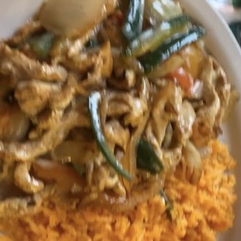 El Mariachi - My customized Pollo dish. Chicken onions tomatoes jalapeños and cheese sauce with rice. Spicy as hell just how I like it! - Mexican Near Me - Indianapolis, Indiana