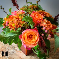 Studio Herbage Florist & Flower Delivery - Autumn Elegance by Studio Herbage Florist - a seasonal selection of autumnal colored botanicals in a rustic cube vase.