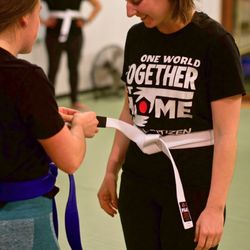 Evolve All - A student receiving a stripe in women's only jiu jitsu!