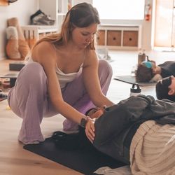 Sacred Ember Wellness Sanctuary - Audrey Rose doing Reiki during a group breathwork session