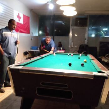 Bula Kava - a man playing pool - Bars Near Me - Hayward, California